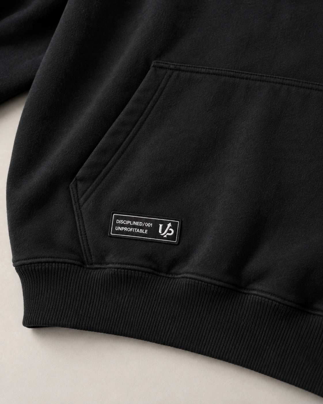 Website studio close-up of the DISCIPLINED woven label